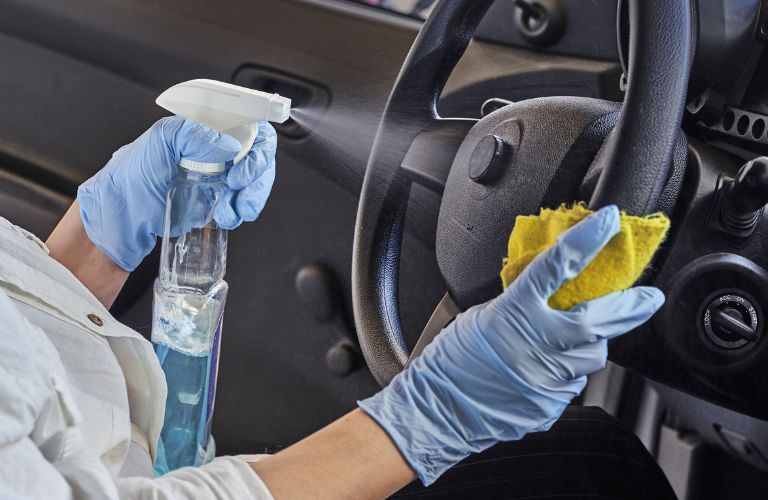 Hands of a lady cleaning a vehicle