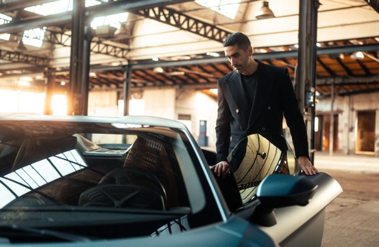 a man getting inside inside a Lamborghini