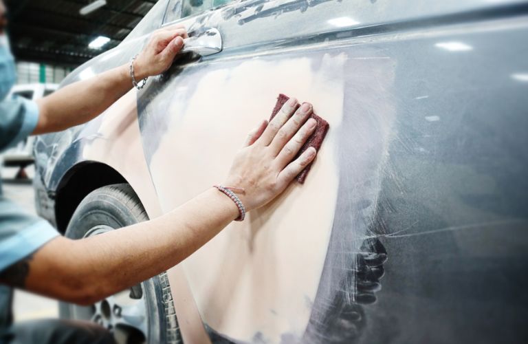a technician detailing a car